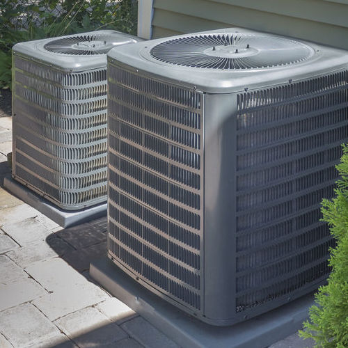 Two Air Conditioning Units Undergoing AC Maintenance