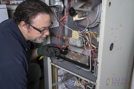 Technician Performing Home Heater Maintenance